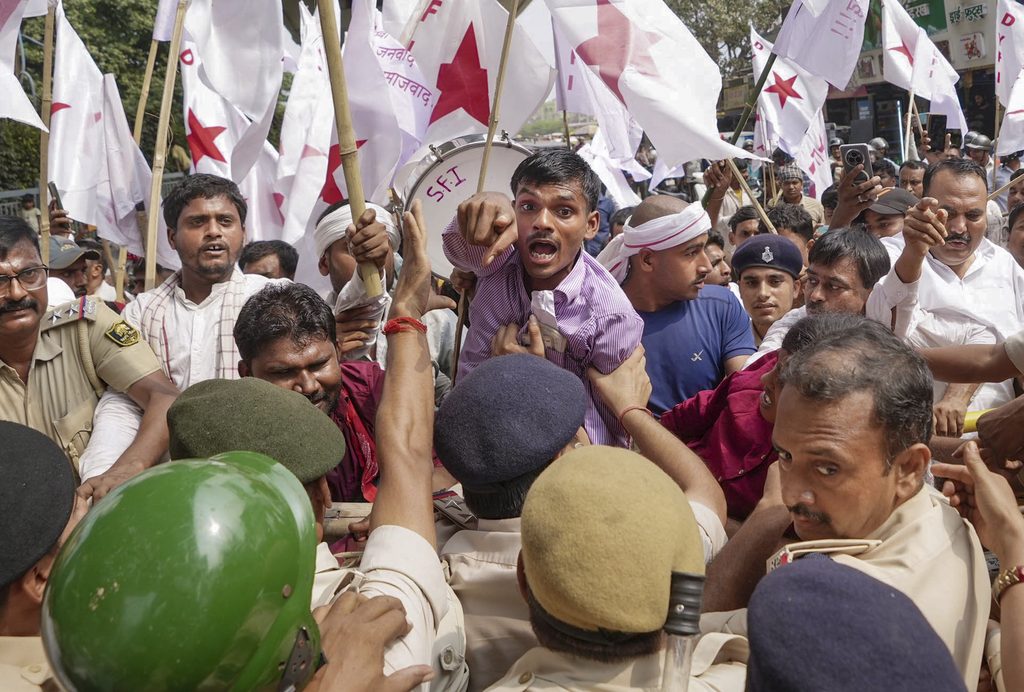 Protesters clash with police during Tiranga march in Delhi, flags and banners visible.