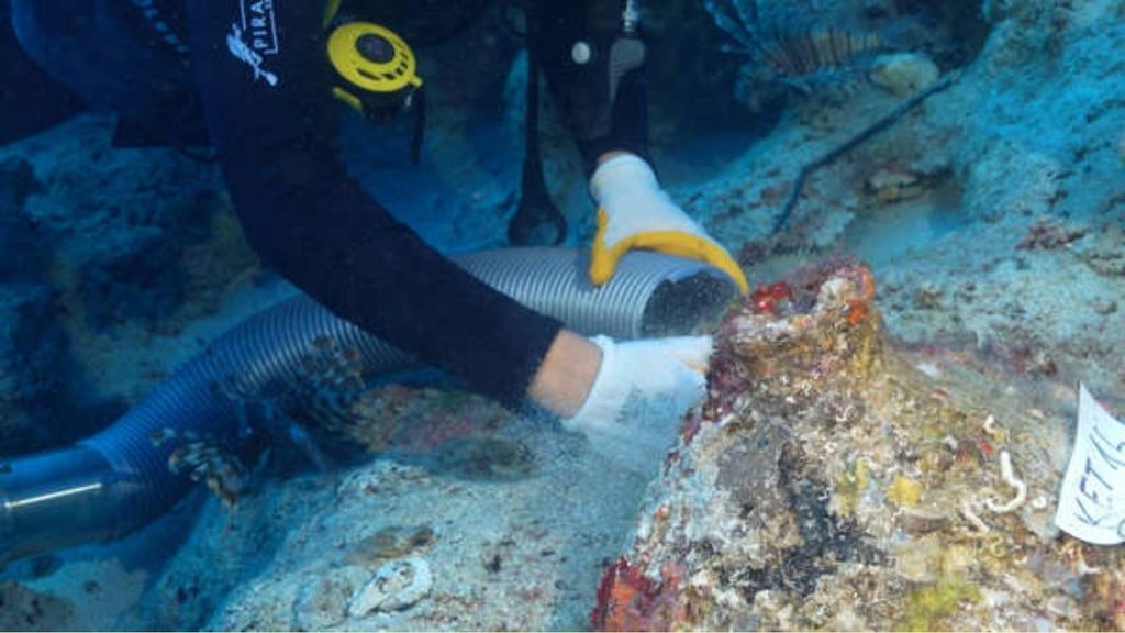 Diver examining an ancient shipwreck on the seabed off Turkey's coast.