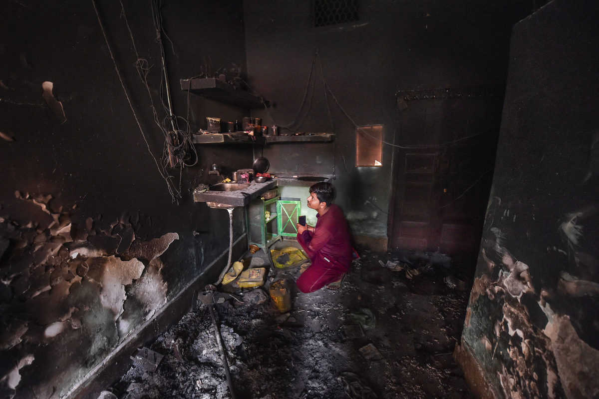  A man inspects a burnt house following clashes over the amended citizenship law, in Khajuri Khas Extension of Northeast Delhi.