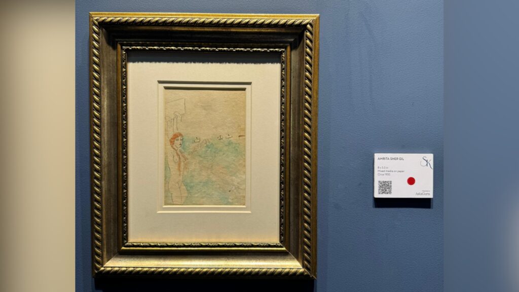 Framed artwork of a woman in a blue dress displayed on a blue gallery wall.