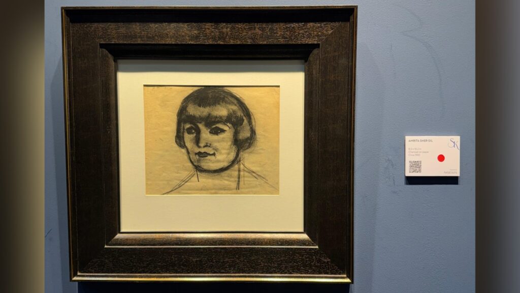 Black and white portrait of a woman with short hair in a dark wooden frame.