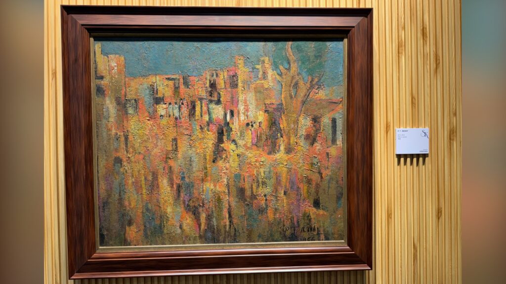 Impressionist-style painting of a colourful cityscape with trees, framed in dark wood.