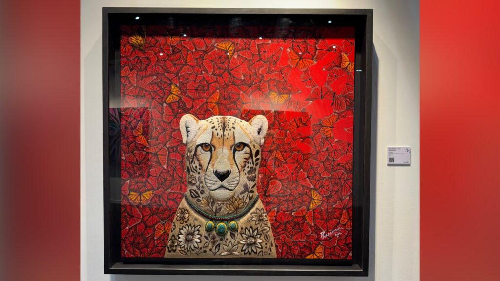 Colourful artwork of a leopard with floral and leaf motifs on a red background.