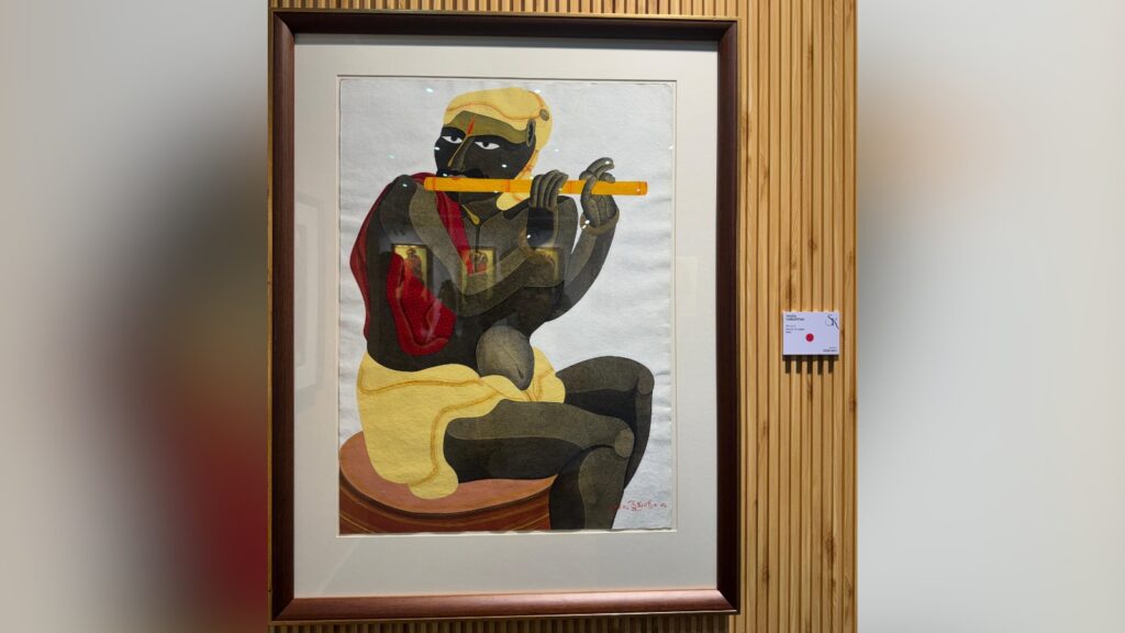 Colourful painting of a seated figure playing a flute, framed and displayed on a wooden wall.