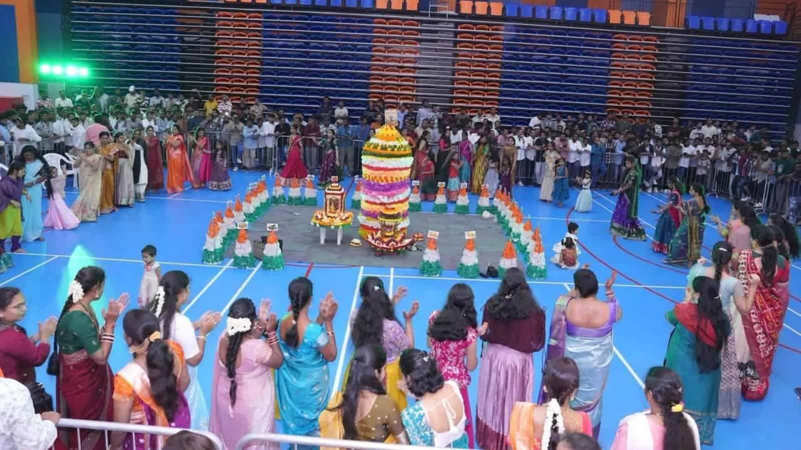 Celebration of Bathukamma festival with women in colourful traditional attire in Dubai.