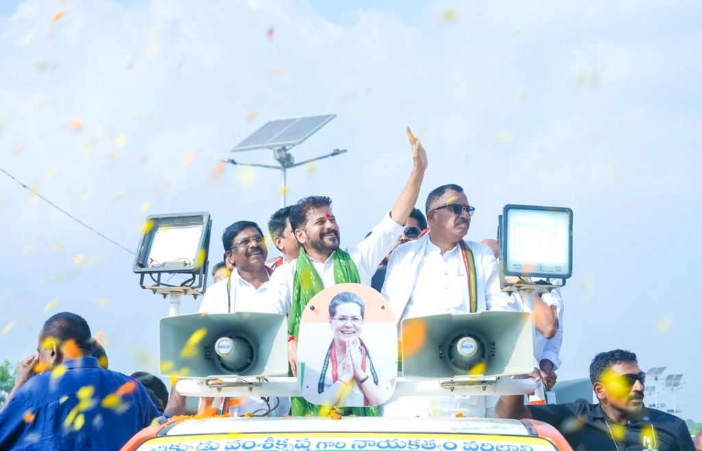 Revanth Reddy at Dasara celebration with supporters and confetti in the air.